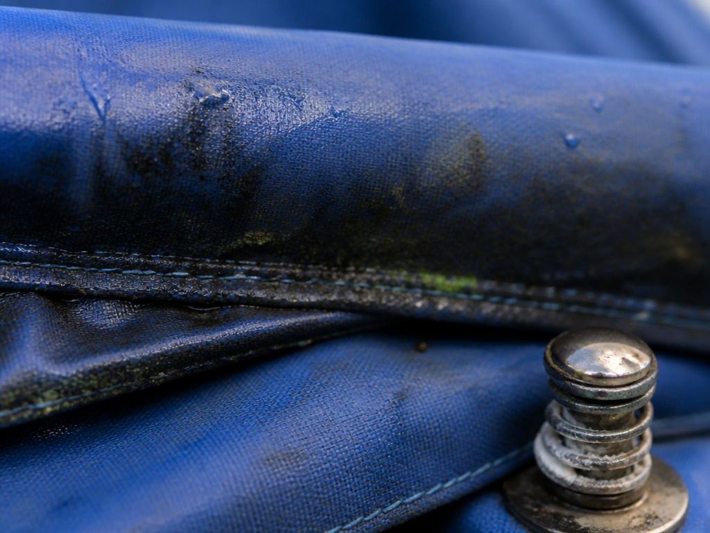 Close-up of mildew and corrosion damage from folding a wet canopy tent.