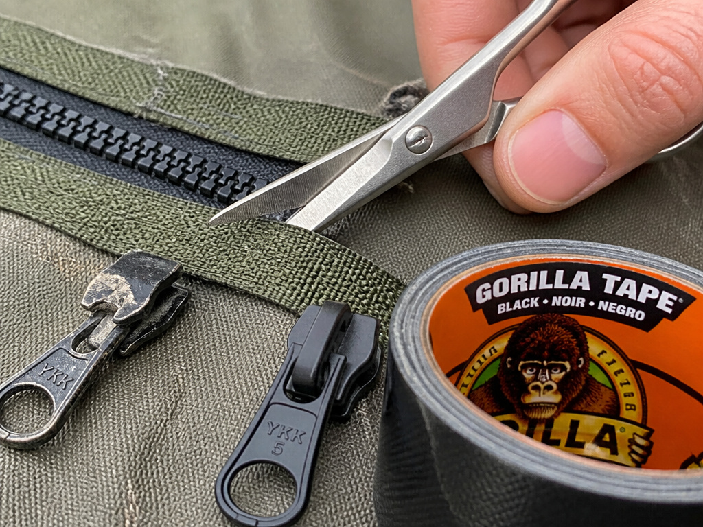 Replacing a broken tent zipper slider with scissors and tape.