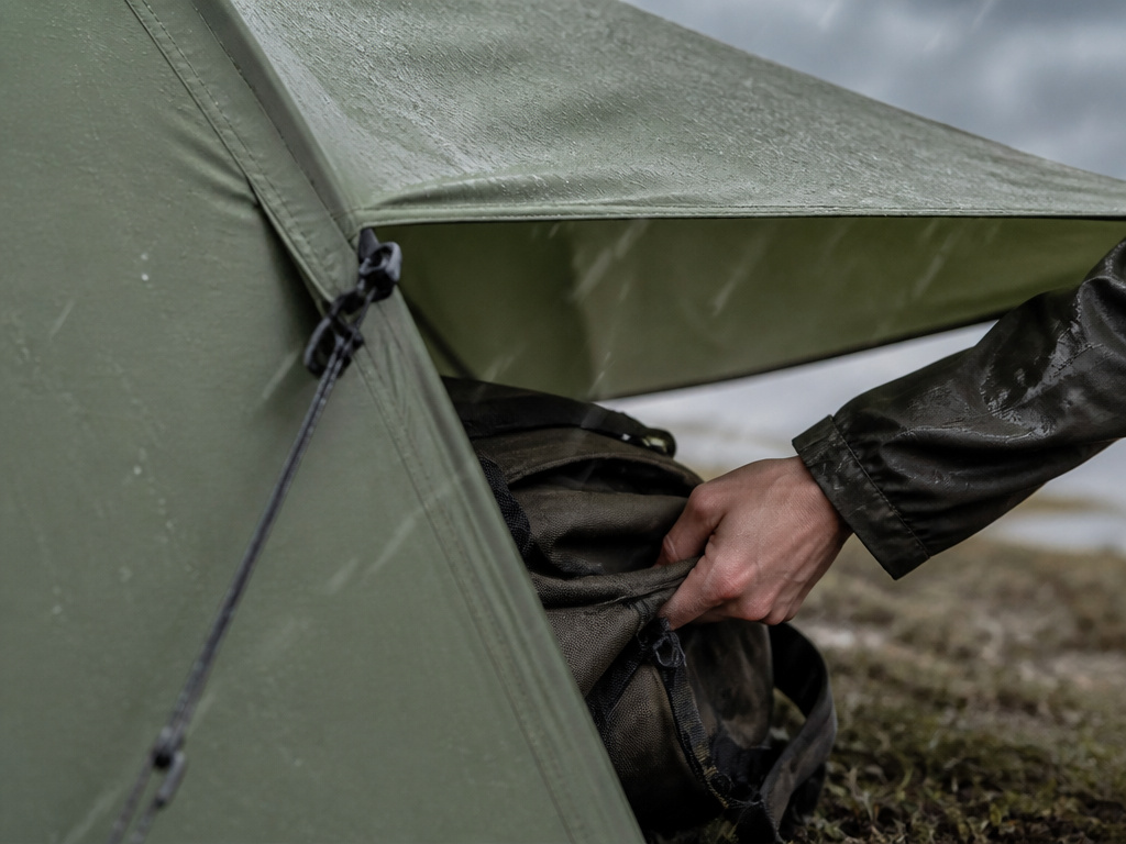 Tent awning extension providing overhead shelter but not full enclosure during rain.