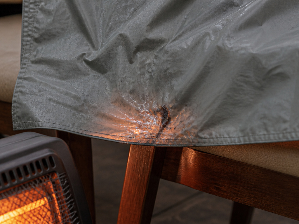 Damaged tent rainfly from improper drying with a space heater.