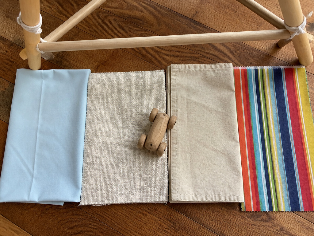 Fabric swatches for a DIY kids tent: sheet, canvas, drop cloth, Sunbrella.